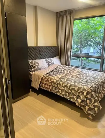 Cozy bedroom with modern decor and large window view