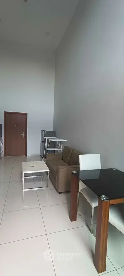 Modern living room with high ceiling and stylish furniture in a contemporary apartment.