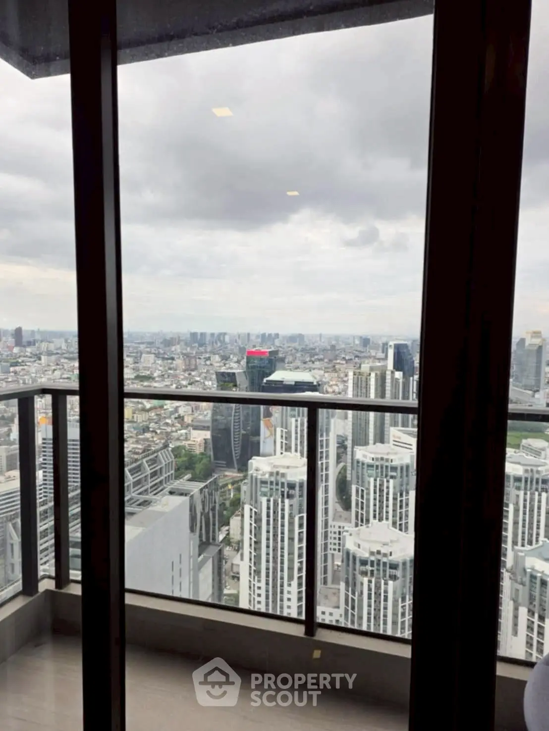 Stunning high-rise balcony view of city skyline with modern architecture.