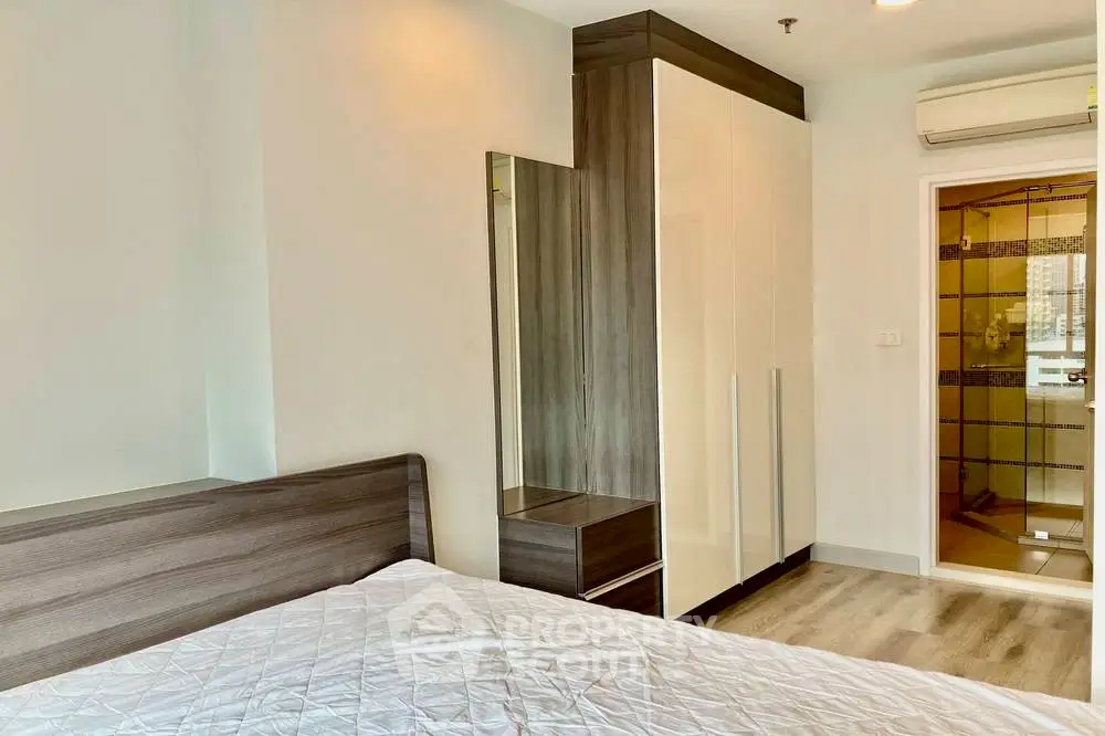 Modern bedroom with ensuite bathroom and sleek wardrobe design