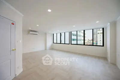 Spacious modern living room with large windows and city view