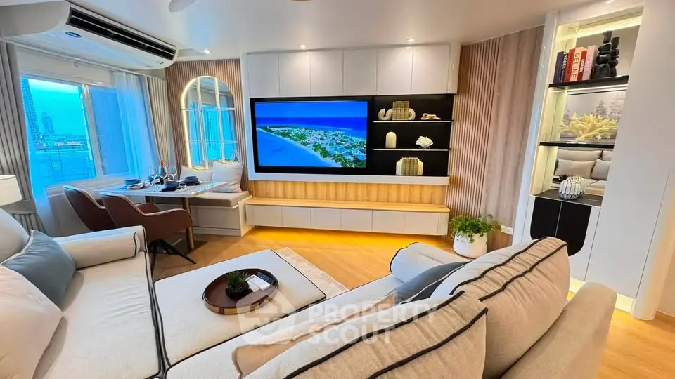 Luxurious modern living room with elegant decor and city view, featuring a large TV and cozy seating area.