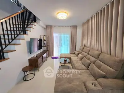 Modern living room with stylish staircase and cozy sectional sofa