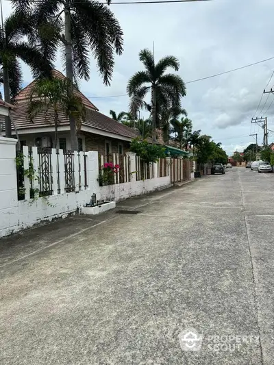 Charming suburban street with lush greenery and cozy homes, perfect for family living.