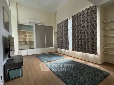 Spacious living room with modern shelving and large windows