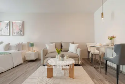 Modern open-plan living room with cozy seating and dining area, featuring stylish decor and natural light.