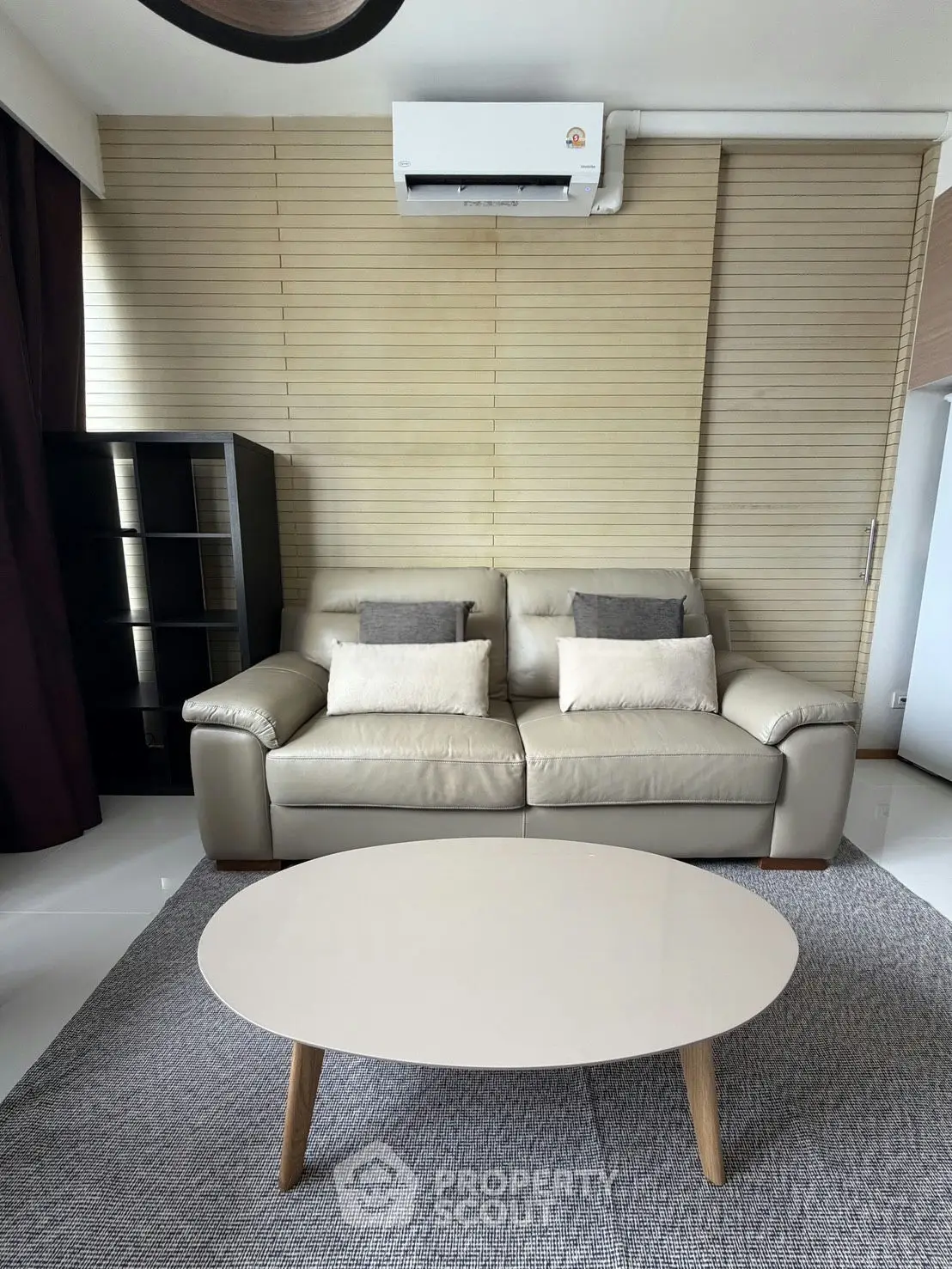 Modern living room with sleek leather sofa and stylish coffee table, perfect for contemporary urban living.