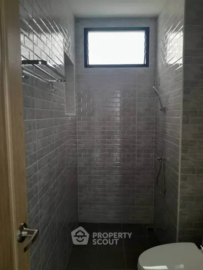 Modern bathroom with sleek gray tiles and minimalist shower design