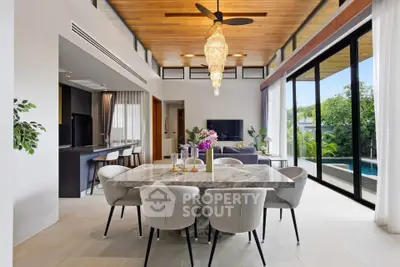Luxurious open-plan living and dining area with pool view and elegant decor