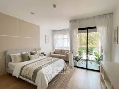 Spacious bedroom with balcony access and modern decor in a bright apartment.