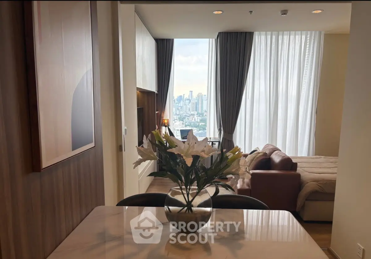 Luxurious apartment interior with stunning city view from living area and elegant decor.