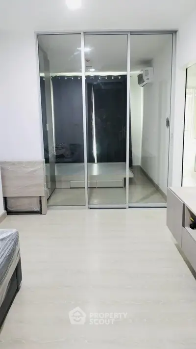 Modern bedroom with sliding glass doors and sleek furnishings