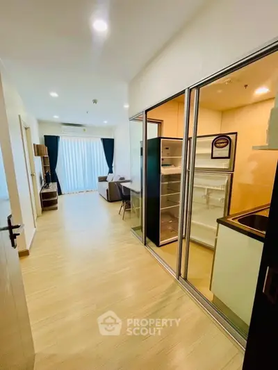 Modern apartment interior with open kitchen and spacious living room, featuring sleek design and natural light.