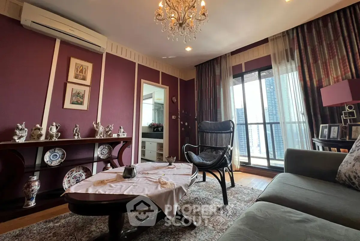 Charming living room with elegant decor and city view, featuring a cozy seating area and stylish chandelier.