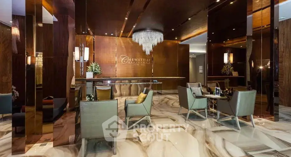 Luxurious hotel lobby with elegant seating and chandelier, showcasing modern design and sophistication.