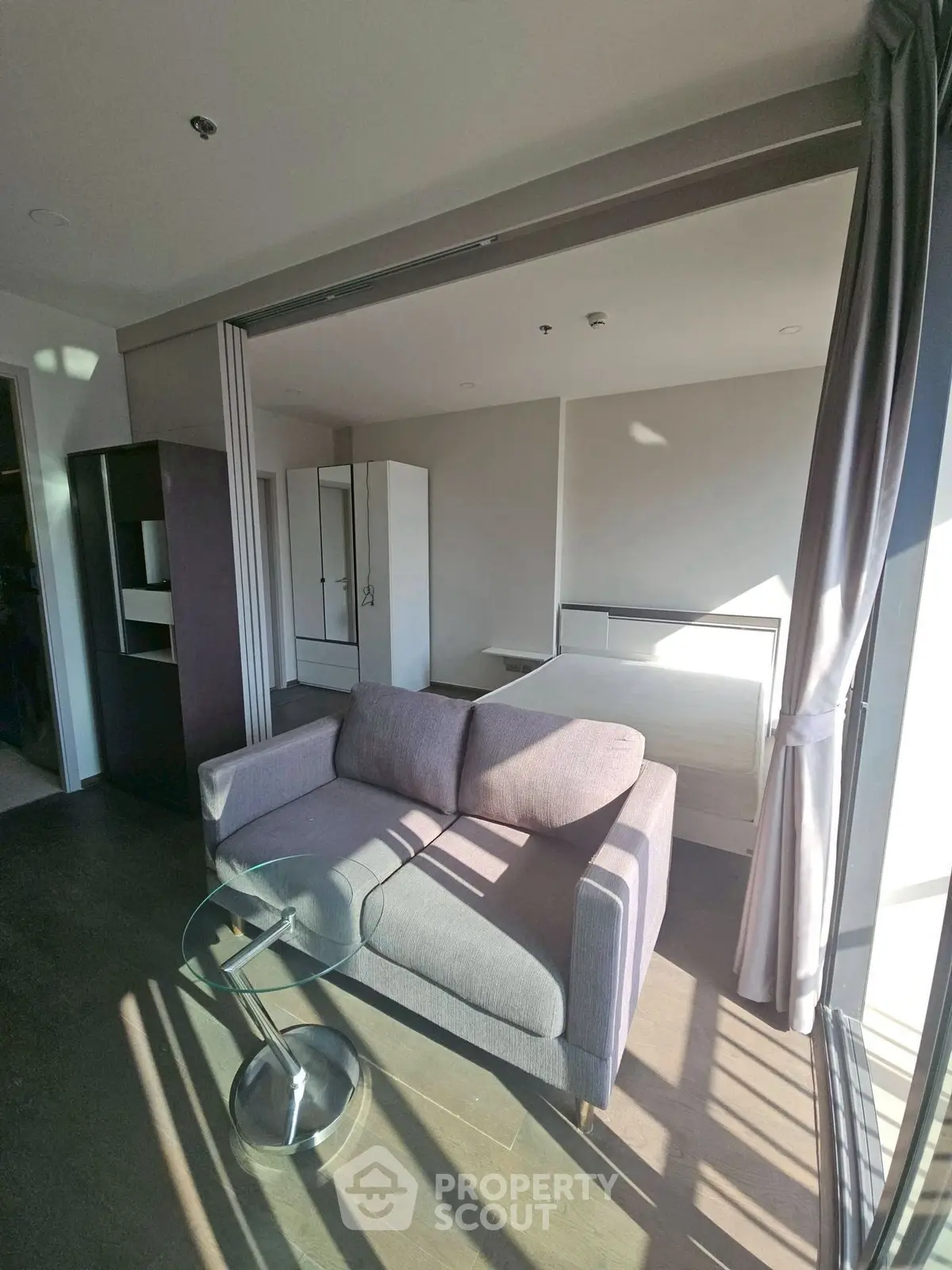 Modern studio apartment with cozy living area and ample natural light