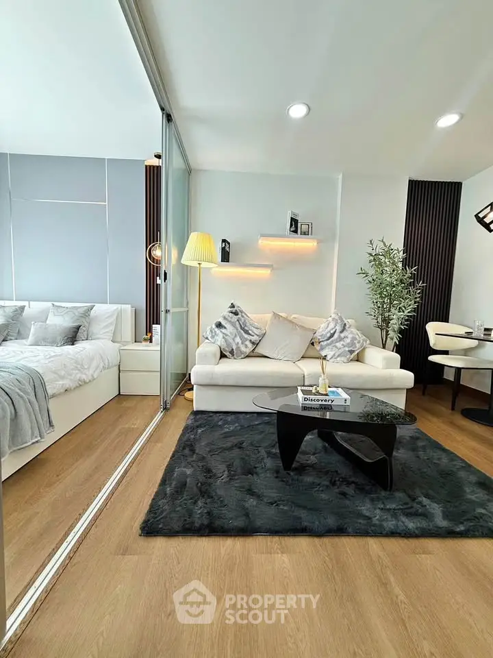Modern living room with cozy seating and stylish decor in a contemporary apartment.