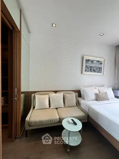 Modern bedroom with cozy seating area and stylish decor