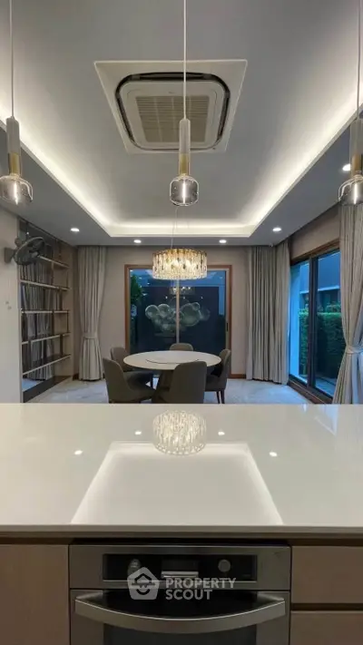 Luxurious modern dining room with elegant lighting and large windows offering garden views.