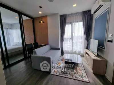 Modern living room with elegant decor and large windows offering natural light.