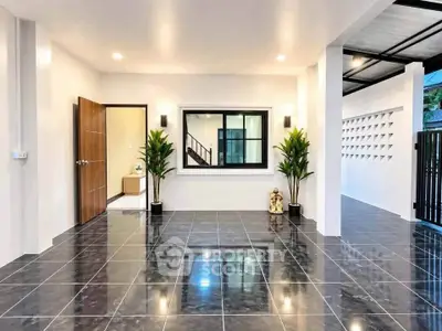 Modern open-plan living area with sleek tile flooring and contemporary design.