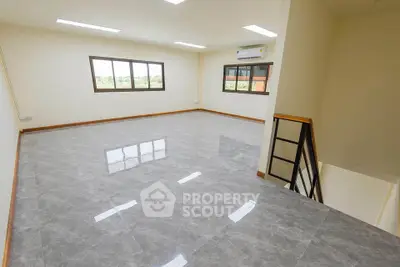 Spacious and bright interior with large windows and modern flooring, perfect for versatile living or office space.