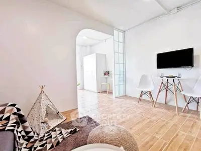 Chic modern living room with minimalist decor and stylish wooden flooring.