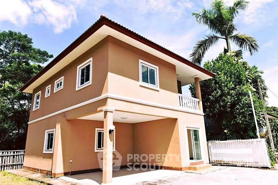 Charming two-story house with spacious balcony and lush surroundings