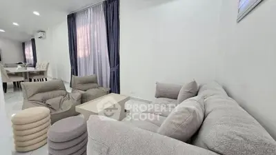 Spacious modern living room with plush seating and elegant dining area, perfect for relaxation and entertaining.