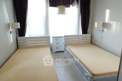 Spacious twin bedroom with natural light and modern decor