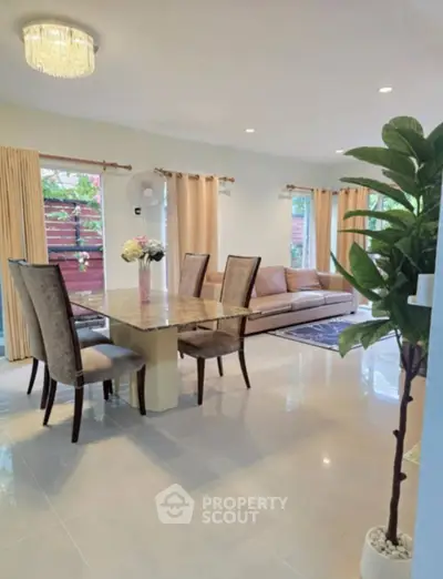 Spacious living room with elegant dining area and natural light