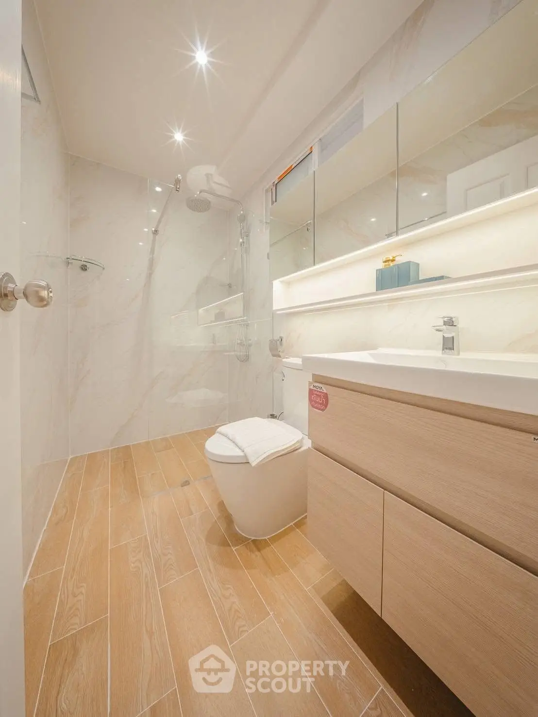 Luxurious modern bathroom with elegant wood flooring and sleek fixtures