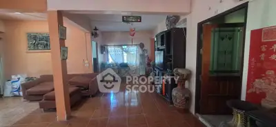 Spacious living room with cozy seating and traditional decor, perfect for family gatherings.