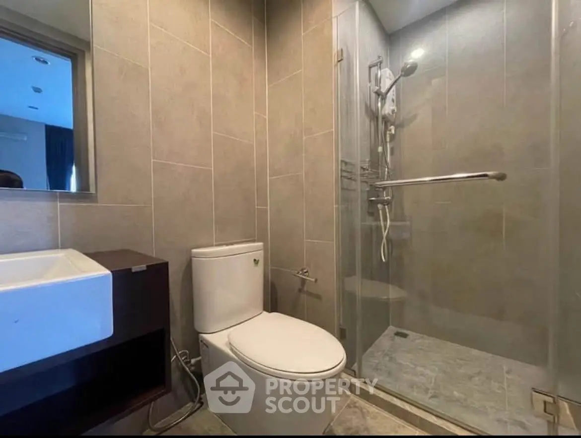 Modern bathroom with glass shower and sleek fixtures