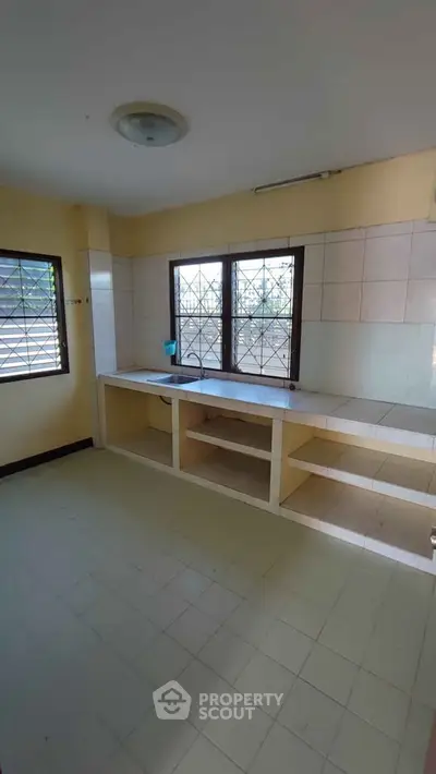 Spacious kitchen with open layout and large windows for natural light.