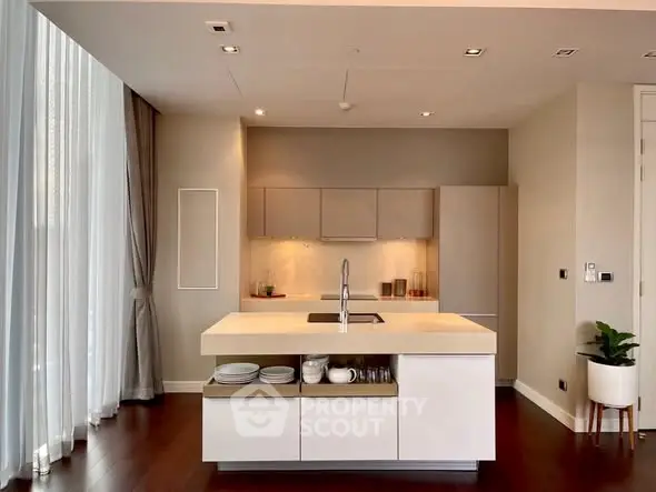 Modern kitchen with island and elegant lighting in luxury apartment