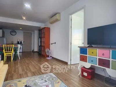 Charming living room with colorful furniture and open layout in modern apartment.