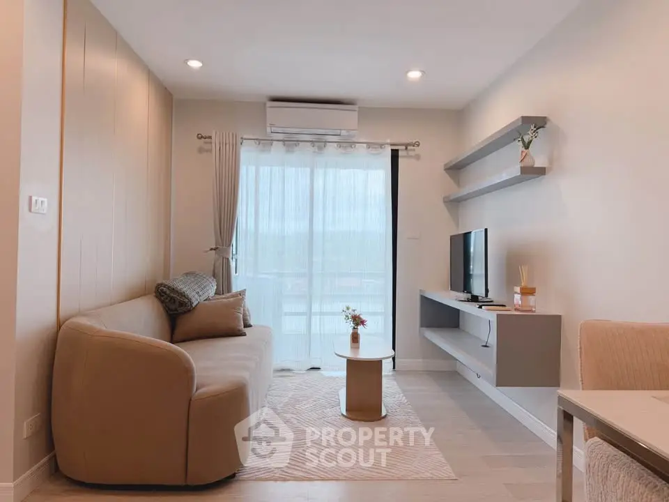 Modern living room with cozy sofa, TV, and balcony view in stylish apartment.