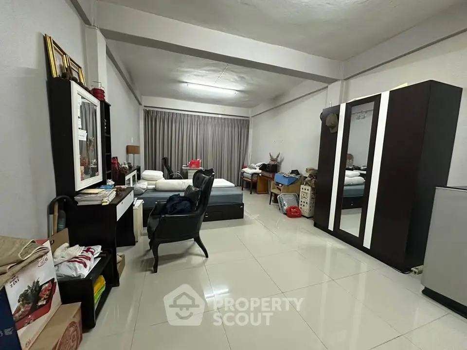 Spacious bedroom with modern furniture and tiled flooring