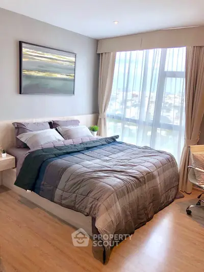 Modern bedroom with large window and stylish decor in a high-rise apartment.