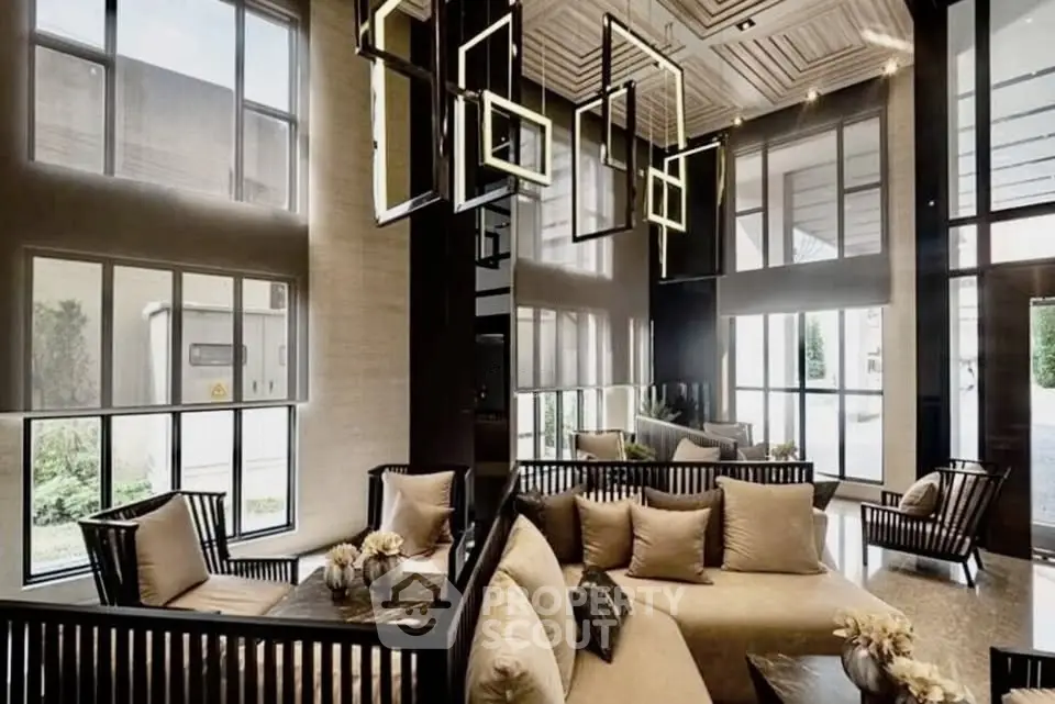 Luxurious modern living room with high ceilings and elegant lighting fixtures.