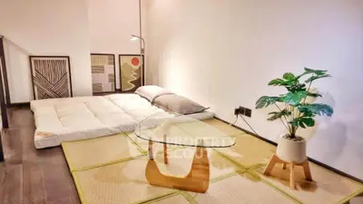 Minimalist Japanese-style living room with tatami mats and modern decor