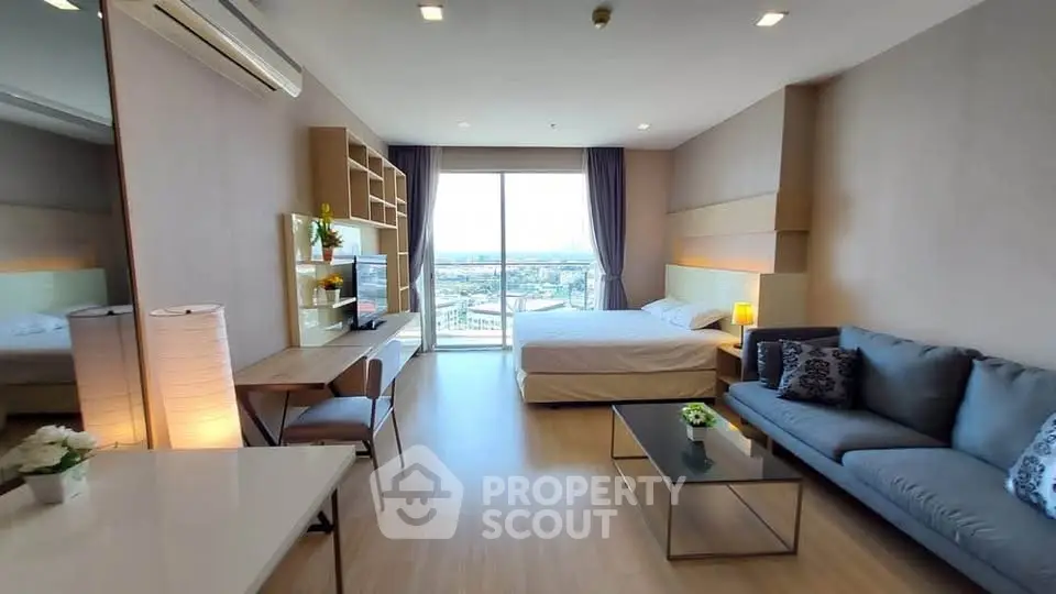 Spacious modern studio apartment with large windows and stylish furnishings