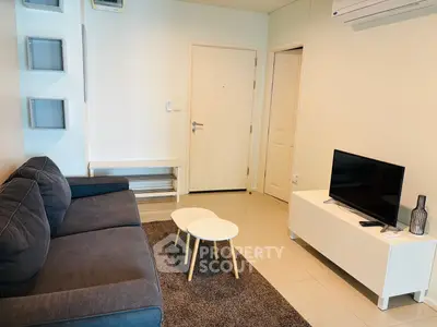 Modern living room with sleek furniture and neutral tones, perfect for relaxation and entertainment.