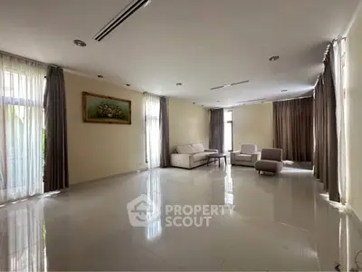 Spacious living room with modern furniture and large windows