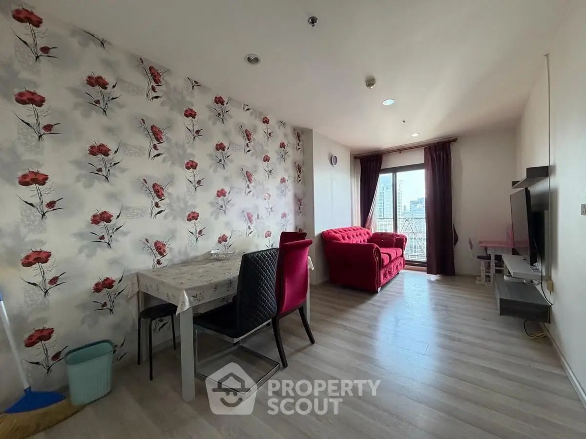 Charming living room with floral accent wall and city view, perfect for cozy urban living.