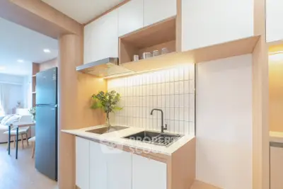 Modern kitchen with sleek design and open layout, featuring built-in appliances and stylish cabinetry.