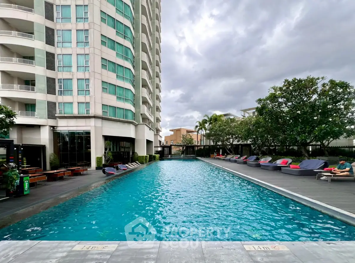 Luxurious high-rise building with stunning poolside view and modern amenities.