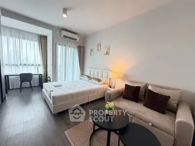Modern studio apartment with cozy living area and natural light