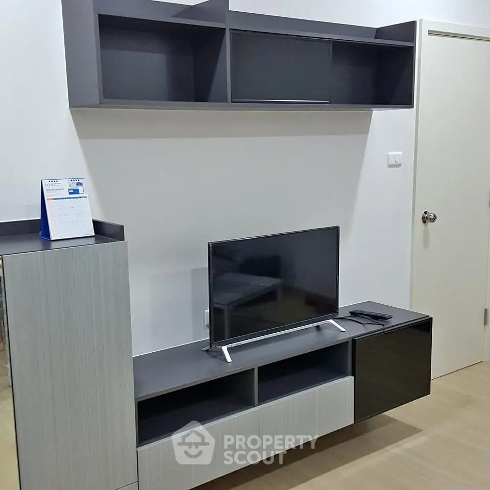 Modern living room with sleek TV stand and wall-mounted shelves, perfect for contemporary urban living.